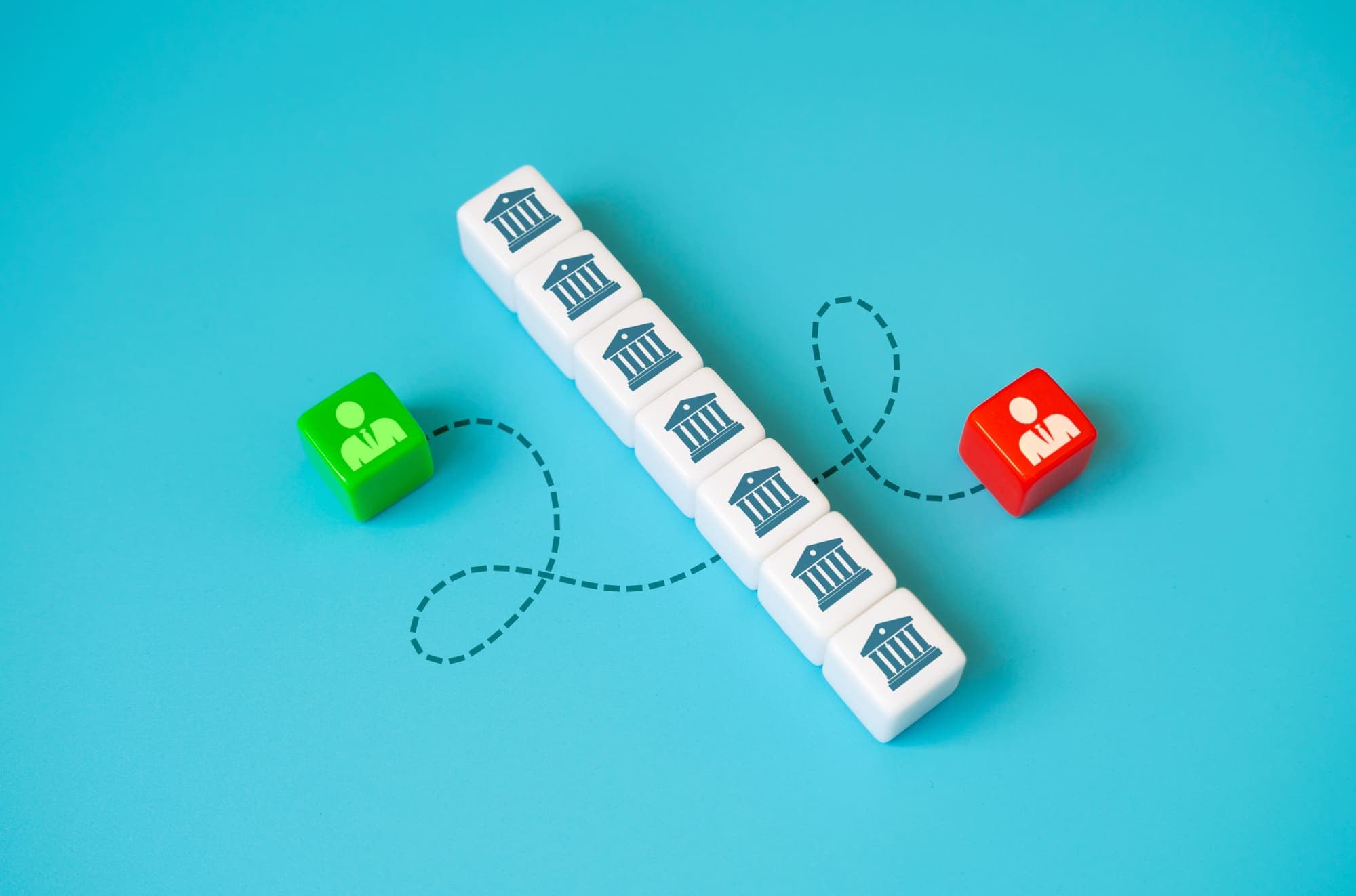 Dice printed with bank symbols linking two figures by a dotted line