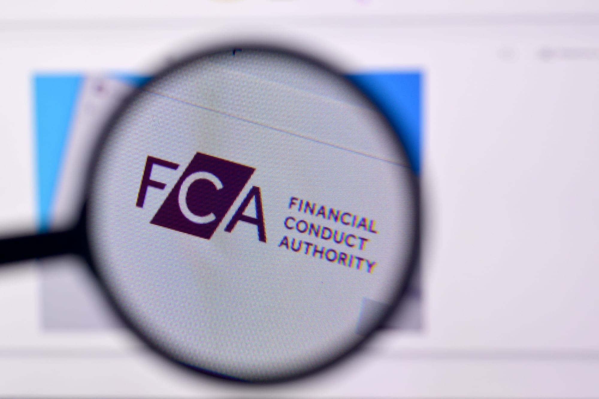 The Financial Conduct Authority logo seen through a magnifying glass