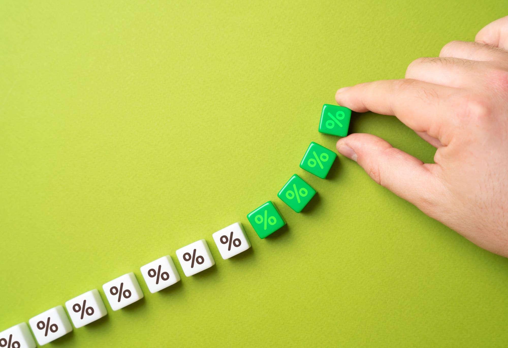Dice marked with percentage signs stepping upward, the rising ones picked out in green